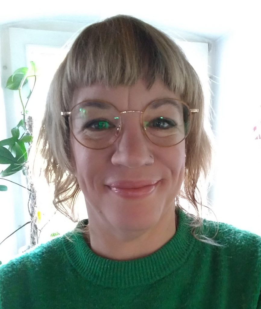 Martina Maderholz. Sie trägt eine Brille und lächelt